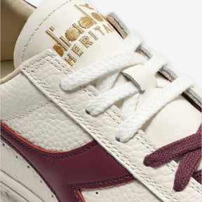 B. Elite Dominio Heritage White/Violet